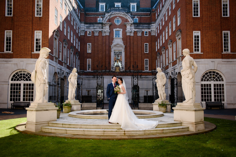 Married couple standing on the BMA fountain